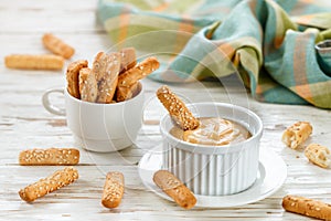 Bread sticks with sesame seeds with sweet mustard dip sauce. Gourmet snack for gourmets photo