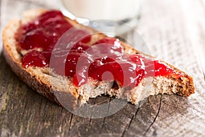 Bread with strawberry jam bited