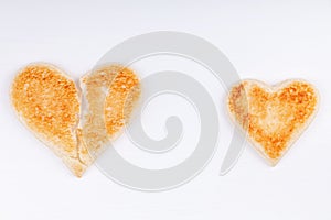 Bread toast broken heart with whole heart together on white background