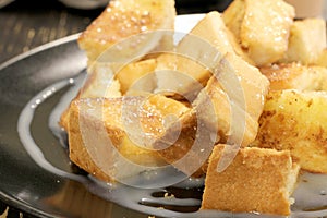 Bread toast with butter and condensed milk in a plate, select focus