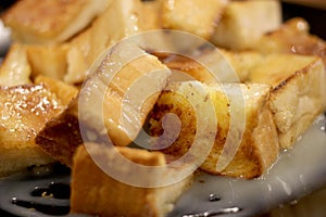 Bread toast with butter and condensed milk in a plate, select focus