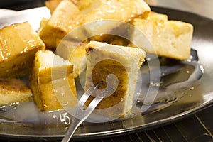 Bread toast with butter and condensed milk in a plate, select focus