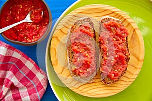 Bread toasted slices with grated tomato photo