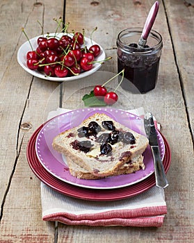 Bread toasts with butter and cherry jam