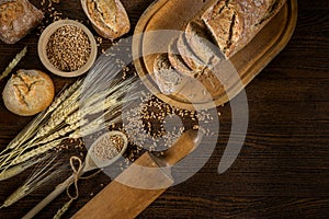 Bread, traditional bread and wheat on wooden backround