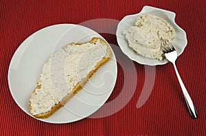 Bread of tuna spread on white plate and bowl