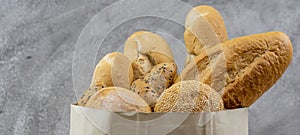 Bread variety in disposalable paper bag. Panoramic