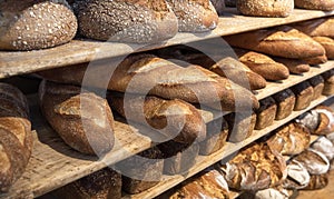 Bread variety on wooden shelves. Bakery goods. Freshly baked