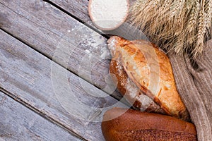 Bread with wheat ears and bowl of flour.