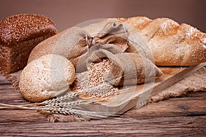 Bread and wheat ears on sacking