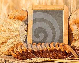 Bread and wheat on the wooden table