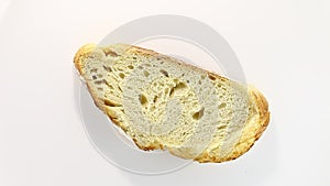 Bread  white, cut piece, rotation, turning counterclockwise, on white background, top macro view.