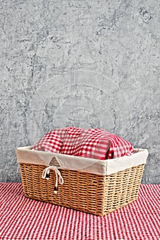 Bread in wicker basket covered with kicthen rag