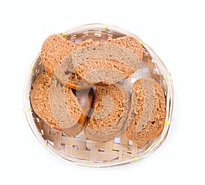 Bread in a wicker breadbasket on white background