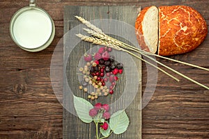 Bread wild berries and cup of milk