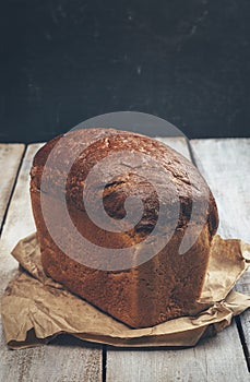 Bread on wooden board. Homebaked bread. Natural food. Slices of bread and a knife on a wooden table