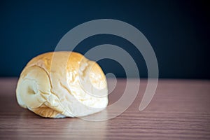 bread on a wooden table and blackboard on background.