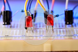 Breadboard with electrical elements, on a wooden table