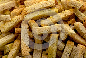 Breadcrumbs in cubes and sticks close-up. Breadcrumbs for beer.Croutons