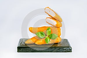 Breaded Chicken Inner Fillet, Chicken Breaded Raw Meat.Breaded Chicken nuggets Fillet with salad on a White Background