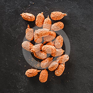 Breaded crab claws on slate stone background. Seafood, top view, flat lay, copy space