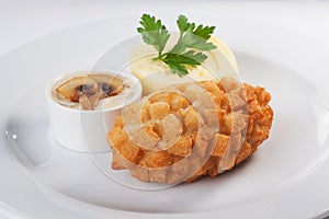 Breaded Cutlet in breadcrumbs with mashed potatoes on a plate, close-up, isolated, white background, menu