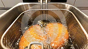 Breaded fillets being finished in the frye