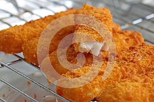 Breaded fish fingers on a grill