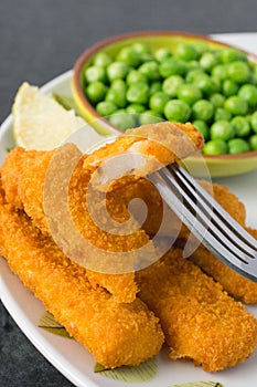 Breaded fish fingers with peas