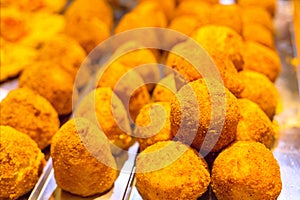 Breaded and fried balls of food likely arancini or croquettes photo
