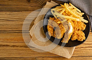 Breaded Fried Chicken Wings, Fingers and Drumsticks on Wooden Rustic Background Top View