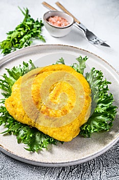 Breaded German Weiner Schnitzel. Gray background. Top view