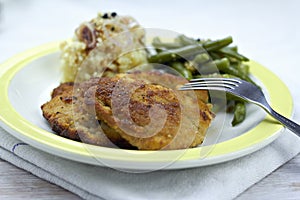 Breaded pork chop with beans