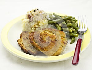 Breaded pork chop with beans