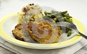 Breaded pork chop with beans