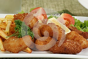 Breaded scampi and chips photo