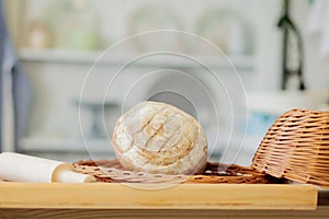 Breads near a wicker basket on a table in a rustic kitchen. Composition in kitchen at the photo studio