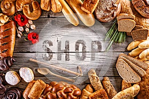 Breads, pastries, christmas cake on wooden background with letters, picture for bakery or shop