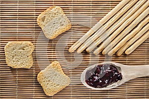Breadsticks, toasts and blueberry jam photo