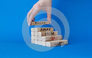 Break away from bad habits symbol. Wooden blocks with words Break away from bad habits. Beautiful blue background. Businessman