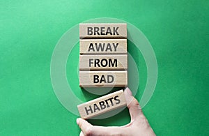 Break away from bad habits symbol. Wooden blocks with words Break away from bad habits. Beautiful green background. Businessman