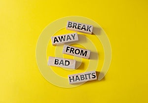 Break away from bad habits symbol. Wooden blocks with words Break away from bad habits. Beautiful yellow background. Business and