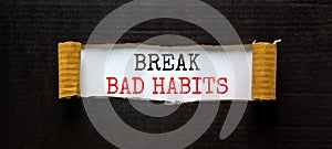 Break bad habits symbol. Words `Break bad habits` appearing behind torn black paper. Beautiful black background. Business,