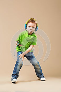 break dance kids. little break dancer showing his skills in dance studio. Hip hop dancer boy performing over studio background