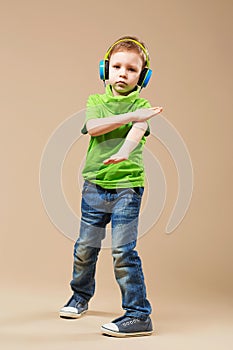 break dance kids. little break dancer showing his skills in dance studio. Hip hop dancer boy performing over studio background