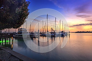 Break of dawn sunrise over boats and sailboats at Factory Bay marina in Marco Island