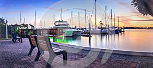 Break of dawn sunrise over boats and sailboats at Factory Bay marina in Marco Island