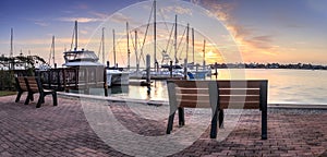 Break of dawn sunrise over boats and sailboats at Factory Bay marina in Marco Island