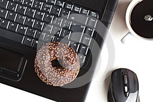 Break in the office . doughnut on laptop keyboard