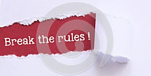 BREAK THE RULES! words on a red sheet and a light background. Concept for innovation, creativity or mischief